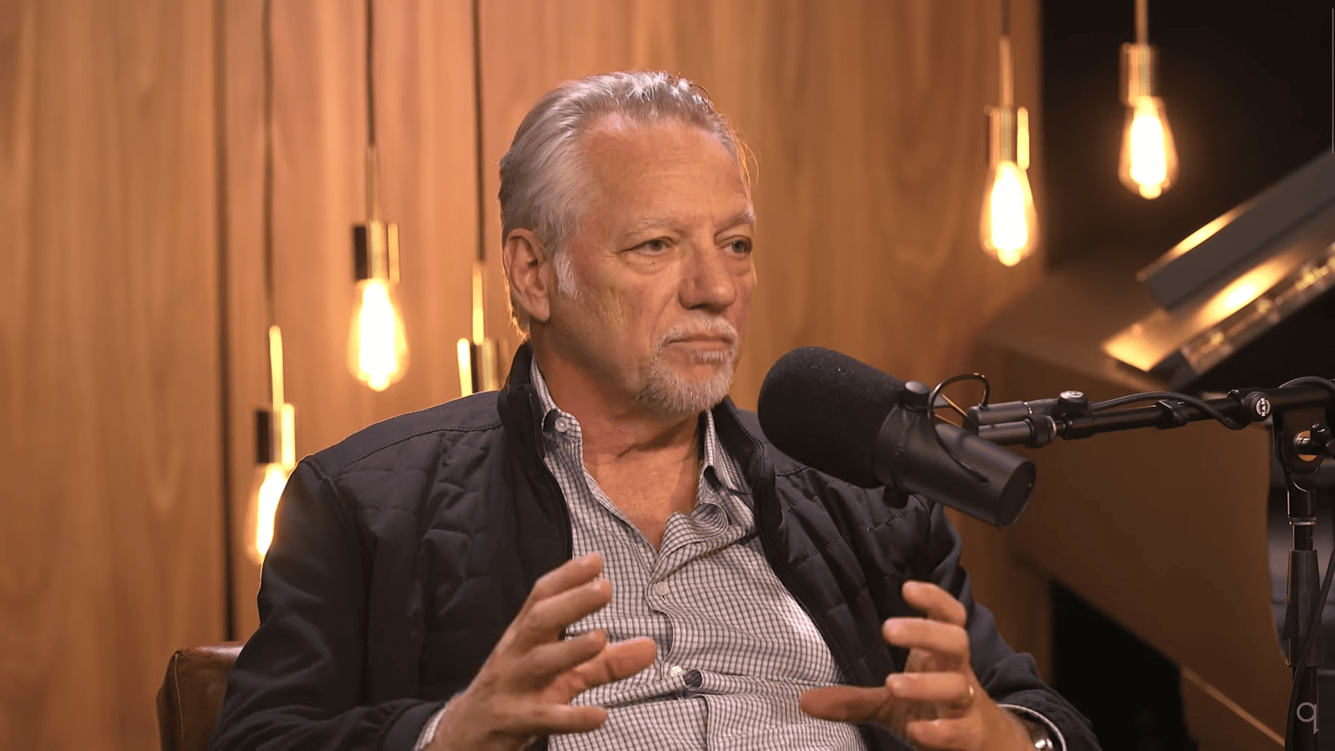 Ed Burtynsky, a light-skinned man with grey hair, giving an interview for radio.