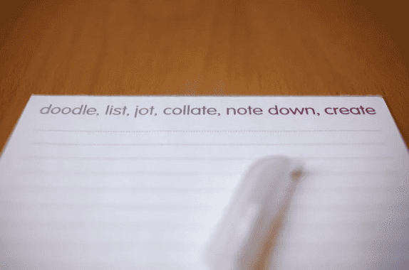 Notebook with margin title that reads, "doodle, list, jot, collate, note down, create."